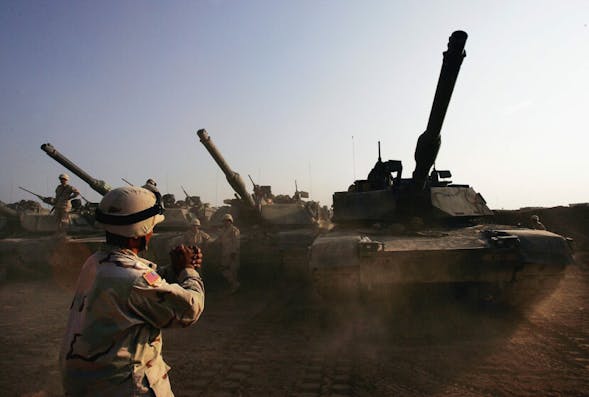 FALLUJA, IRAQ – NOVEMBER 4:  U.S. Army tanks are moved into a base, on November 4, 2004 on the outskirts of Falluja, Iraq. Several thousand U.S. troops are poised for a massive strike near the restive Suni and insurgent stronghold of Fallujah, and Iraqi President Allawi has warned that negotiations with local insurgents to reach a peaceful solution have nearly run their course.  (Photo by Scott Nelson/Getty Images)