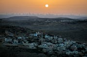 TOPSHOT – A picture taken from the Israeli settlement of Naale in the occupied West Bank northwest of the Palestinian city of Ramallah shows the skyline of the Israeli coastal city of Tel Aviv on June 17, 2020. – The government of Israeli Prime Minister Benjamin Netanyahu has said it could begin  the process to annex Jewish settlements in the West Bank as well as the strategic Jordan Valley from July 1. The plan — endorsed by Washington — would see the creation of a Palestinian state, but on reduced territory, and without Palestinians’ core demand of a capital in east Jerusalem. (Photo by MENAHEM KAHANA / AFP) (Photo by MENAHEM KAHANA/AFP via Getty Images)