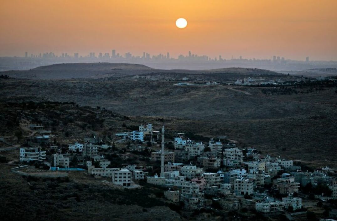 TOPSHOT – A picture taken from the Israeli settlement of Naale in the occupied West Bank northwest of the Palestinian city of Ramallah shows the skyline of the Israeli coastal city of Tel Aviv on June 17, 2020. – The government of Israeli Prime Minister Benjamin Netanyahu has said it could begin  the process to annex Jewish settlements in the West Bank as well as the strategic Jordan Valley from July 1. The plan — endorsed by Washington — would see the creation of a Palestinian state, but on reduced territory, and without Palestinians’ core demand of a capital in east Jerusalem. (Photo by MENAHEM KAHANA / AFP) (Photo by MENAHEM KAHANA/AFP via Getty Images)