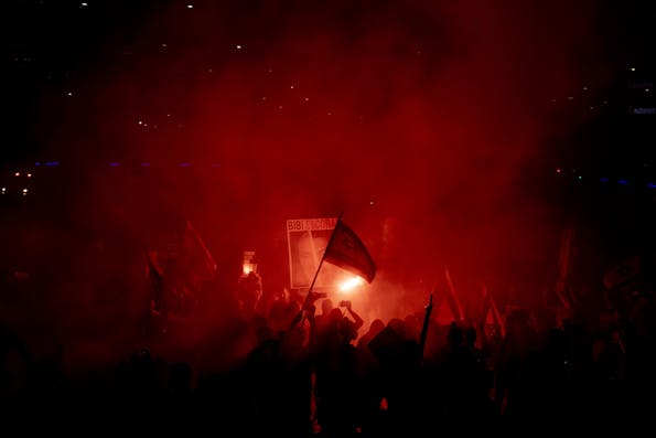 TEL AVIV, ISRAEL – JUNE 15: Protesters use smoke torches during a demonstration calling for an hostages deal and against the Israeli Prime Minister Benjamin Netanyahu and his government on June 15, 2024 in Tel Aviv, Israel. Anti-government protests have taken place most Saturdays this year, amid frustration with the Netanyahu government and its failure to secure the release of the remaining hostages captured on Oct. 7.(Photo by Amir Levy/Getty Images)