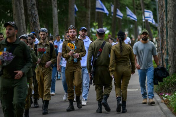 JERUSALEM – MAY 13: IDF soldiers carry flowers  at Har Hertzel on Yom HaZikaron on May 13, 2024 in Jerusalem. On Yom HaZikaron, Israel Memorial Day, Israeli society comes together to mourn fallen soldiers who died for the nation’s independence, as well as civilian victims of terror. This year, from sundown on May 12 to sundown on May 13, the day of grief is marked by ceremonies held at military cemeteries across the country. Yom HaAtzmaut, Israeli Independence Day, follows in celebration. This is the first Yom HaZikaron since October 7th. (Photo by Alexi J. Rosenfeld/Getty Images)