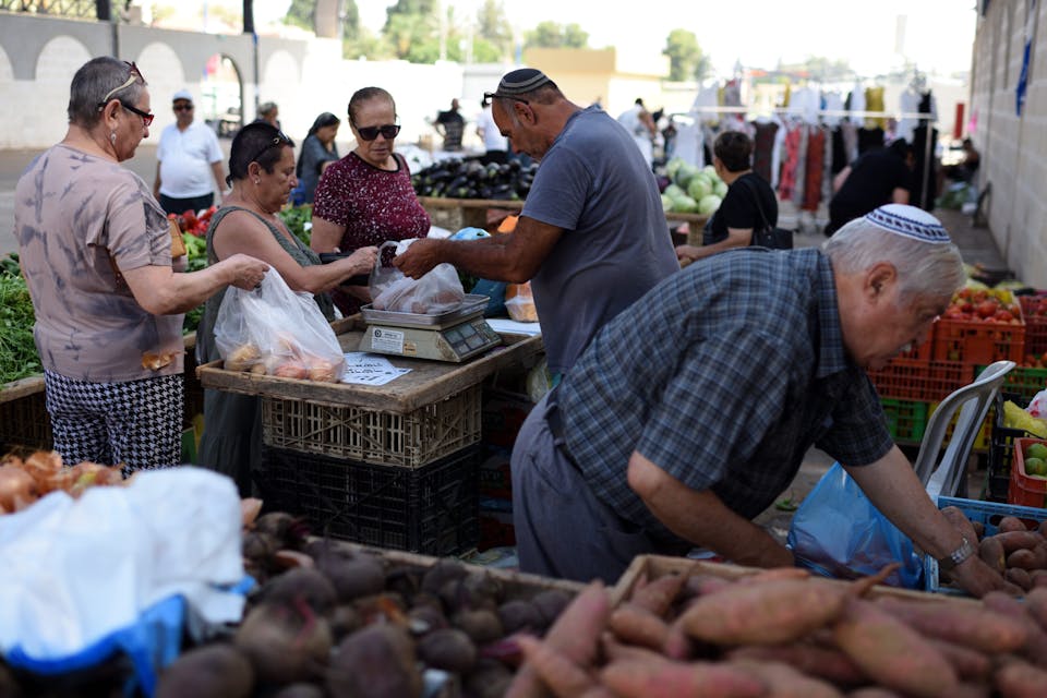 Israelis at a market in Sderot. *Gili Yaari/NurPhoto via Getty Images*. SDEROT, ISRAEL – July 15, 2018: (ISRAEL OUT) Israelis at the local market in the Southern city of Sderot, located near the Israel-Gaze border as a cease-fire holds after day of intense Israel-Hamas fighting. (Photo by Gili Yaari/NurPhoto via Getty Images)