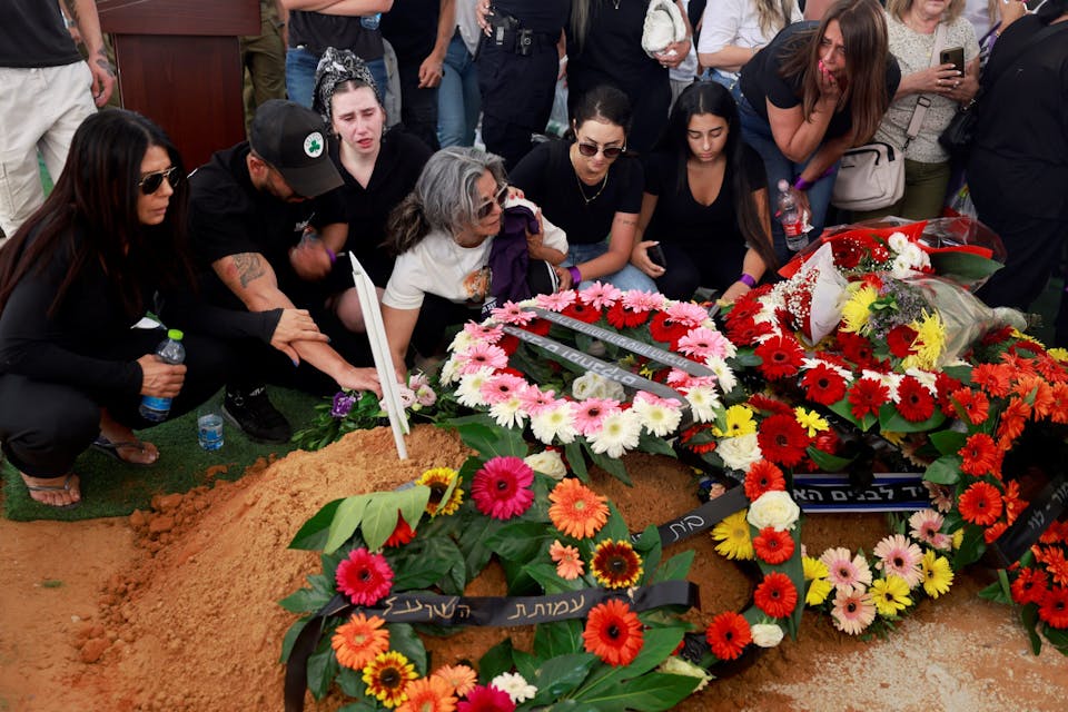 Relatives and friends grieve at the grave during the funeral of Israeli soldier Almog Shalom in Mount Herzl Military Cemetery in Jerusalem on June 11, 2024, the day after he was killed with three other soldiers in the Gaza Strip, amid the ongoing conflict between Israel and the Palestinian Hamas militant group. The Israeli military said that four soldiers had been killed in fighting in southern Gaza on June 10, more than eight months into its war against Hamas militants. The soldiers were “killed in fighting in south Gaza” the military said in a statement, without elaborating on the circumstances of their deaths. (Photo by Menahem Kahana / AFP) (Photo by MENAHEM KAHANA/AFP via Getty Images)