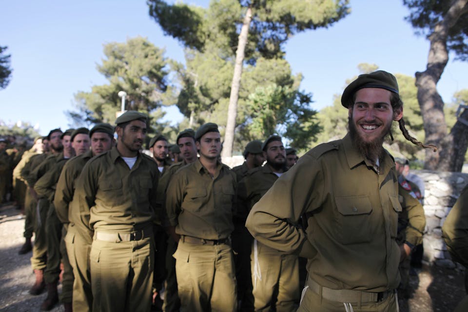 JERUSALEM, ISRAEL – MAY 26:  (ISRAEL OUT)  Ultra-Orthodox Israelis gather prior to a military graduation ceremony on May 26, 2013 in Jerusalem, Israel. The Netzah Yehuda battalion was formed in 1999 with the aim of creating a unit which would allow ultra-othodox Israelis to take a role in the military. Traditionally exempted from compulsory conscription, Government plans to invoke compulsory drafts for ultra-Othodox to military service has led to violent protests and the subsequent postponement of public graduation ceremonies in recent days. (Photo by Lior Mizrahi/Getty Images)