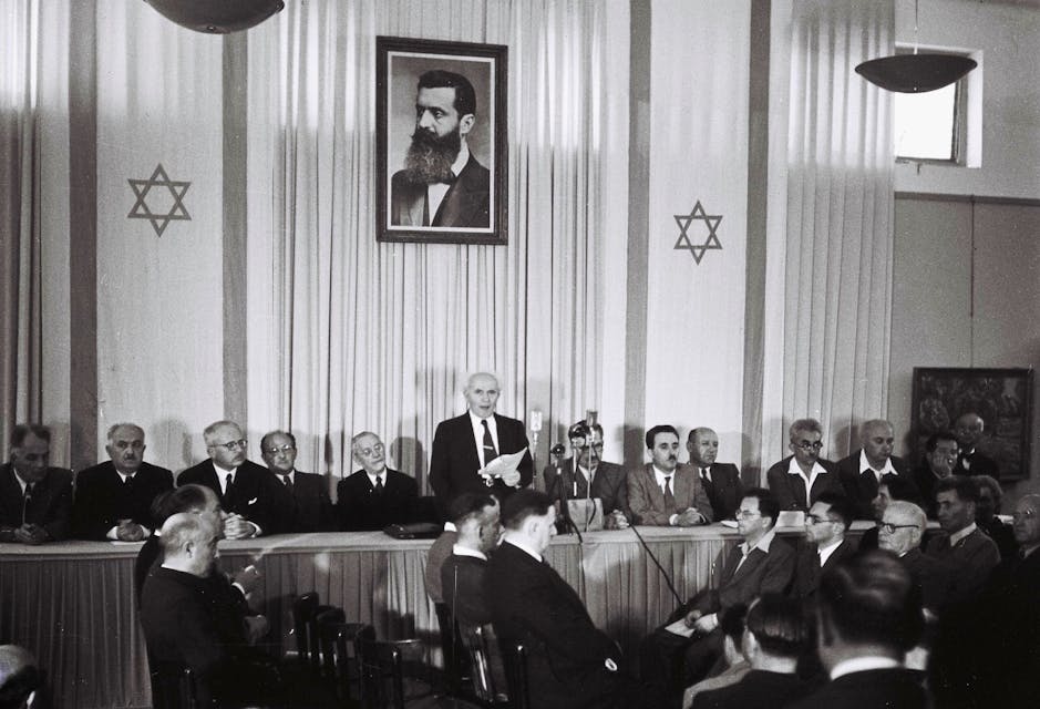 TEL AVIV, ISRAEL – MAY 14:  In this handout from the GPO, David Ben Gurion, who was to become Israel’s first Prime Minister, reads the Declaration of Independence May 14, 1948 at the museum in Tel Aviv, during the ceremony founding the State of Israel. (Photo by Zoltan Kluger/GPO via Getty Images)