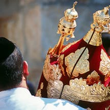 A man holds a Torah scroll torah-scroll