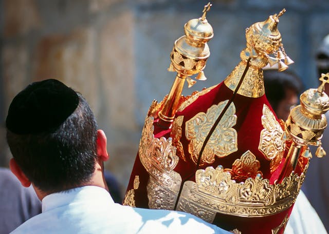 A man holds a Torah scroll torah-scroll