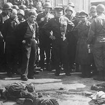 640px-Gen_Eisenhower_at_death_camp_report_crop