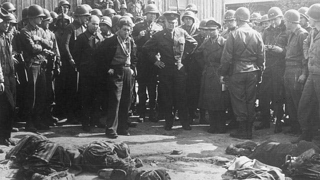 640px-Gen_Eisenhower_at_death_camp_report_crop