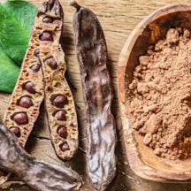 Carob,Pods,And,Carob,Beans,On,The,Wooden,Table.