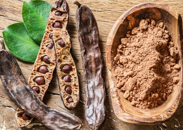 Carob,Pods,And,Carob,Beans,On,The,Wooden,Table.