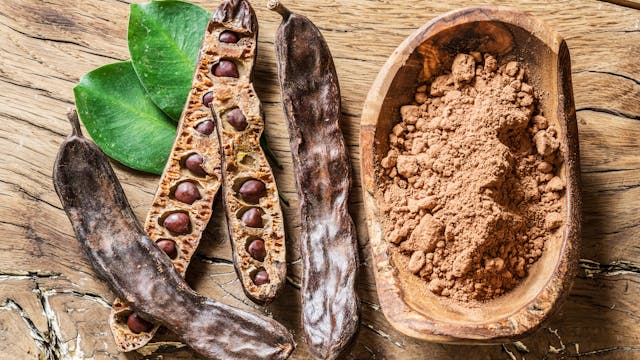 Carob,Pods,And,Carob,Beans,On,The,Wooden,Table.