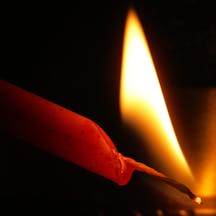 Flame,Of,A,Red,Candle,On,A,Black,Background,,Lighting