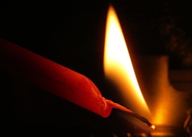 Flame,Of,A,Red,Candle,On,A,Black,Background,,Lighting