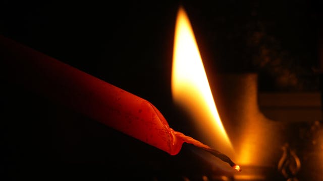 Flame,Of,A,Red,Candle,On,A,Black,Background,,Lighting