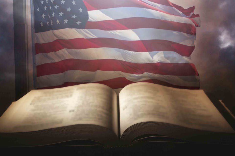 Holy,Bible,With,The,American,Flag,In,The,Background.