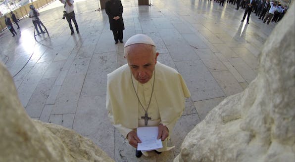 JERUSALEM, ISRAEL – MAY 26:  (ISRAEL OUT)  In this handout provided by the Israeli Government Press Office (GPO), Pope Francis prays at the Western Wall, on May 26, 2014 in Jerusalem, Israel. Pope Francis arrived in Israel on Sunday afternoon, a day after landing in the Middle East for his first visit to the Holy Land. During his visit to the West Bank the Pontiff addressed the Israeli-Palestinian conflict as “unacceptable” and urged both sides to find courage in seeking a peaceful solution. (Photo by Kobi Gideon – GPO /Getty Images)