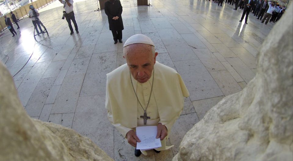 JERUSALEM, ISRAEL – MAY 26:  (ISRAEL OUT)  In this handout provided by the Israeli Government Press Office (GPO), Pope Francis prays at the Western Wall, on May 26, 2014 in Jerusalem, Israel. Pope Francis arrived in Israel on Sunday afternoon, a day after landing in the Middle East for his first visit to the Holy Land. During his visit to the West Bank the Pontiff addressed the Israeli-Palestinian conflict as “unacceptable” and urged both sides to find courage in seeking a peaceful solution. (Photo by Kobi Gideon – GPO /Getty Images)