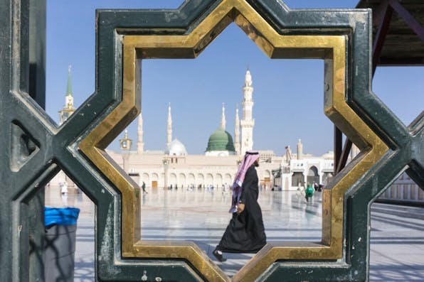 A man walks through the Nabawi mosque compound in Medina, Saudi Arabia (December 18, 2014). *Shutterstock.* sa-magen-david