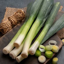 Whole,And,Cut,Fresh,Leeks,On,A,Dark,Background,,Vegetarian