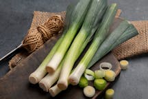 Whole,And,Cut,Fresh,Leeks,On,A,Dark,Background,,Vegetarian