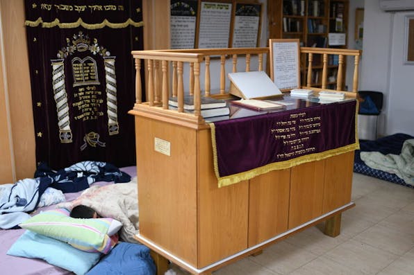 An Israeli child sleeps in a public bomb shelter-turned-synagogue in Ashkelon during a Hamas rocket attack (May 18, 2021). *Gili Yaari/NurPhoto via Getty Images.* An Israelis kid is sleeping in a public bomb shelter, generaly used as synagogue, during a rocket barrage fired from the Gaza strip on May 18, 2021 at the Southern city of Ashkelon. (Photo by Gili Yaari/NurPhoto via Getty Images)