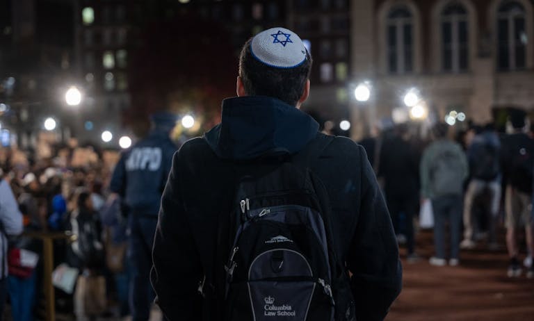 A Jewish student watches an anti-Israel protest at Columbia University in November 2023 *Getty Images*