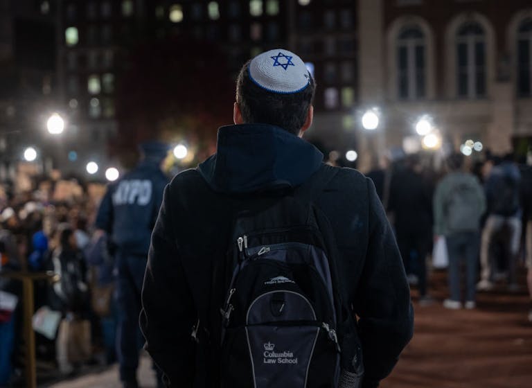 A Jewish student watches an anti-Israel protest at Columbia University in November 2023 *Getty Images*