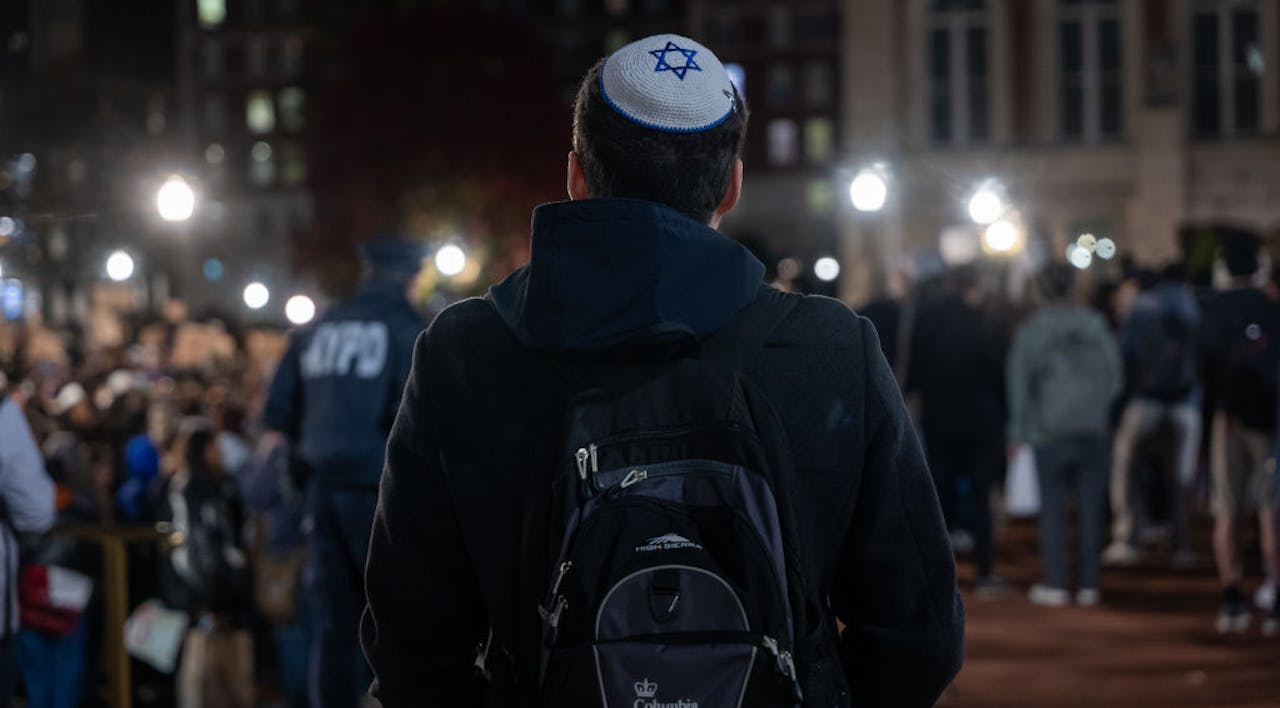 A Jewish student watches an anti-Israel protest at Columbia University in November 2023 *Getty Images*