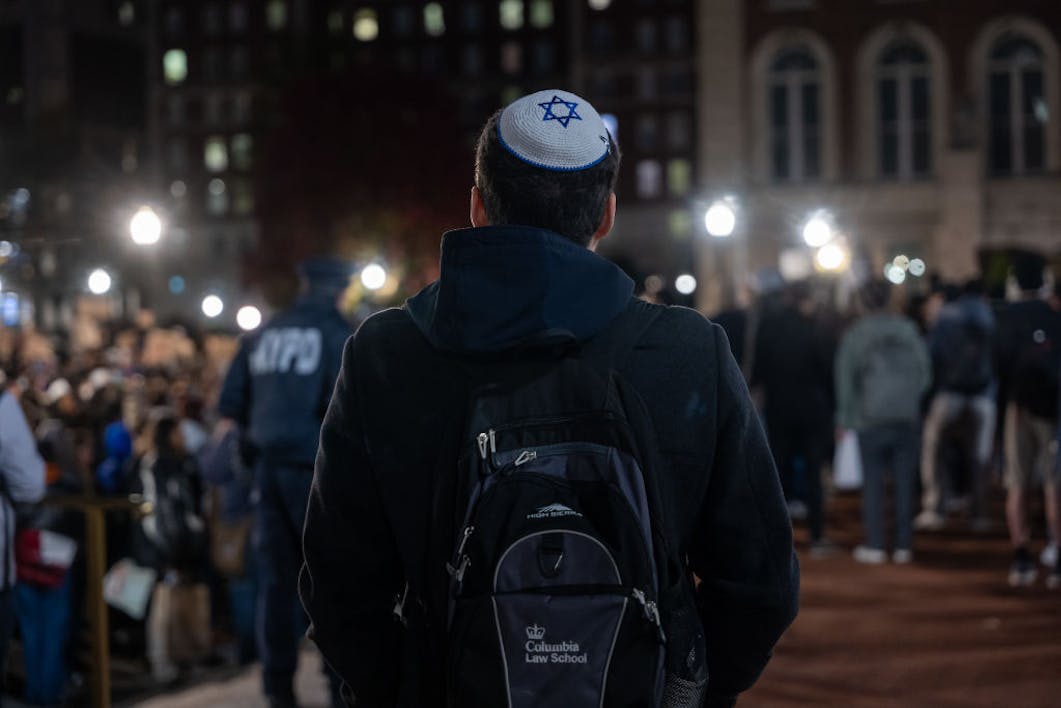 A Jewish student watches an anti-Israel protest at Columbia University in November 2023 *Getty Images*