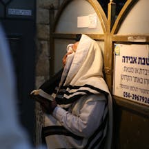 Man Covering Eyes While Praying