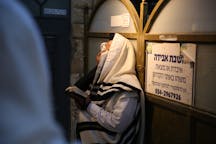 Man Covering Eyes While Praying