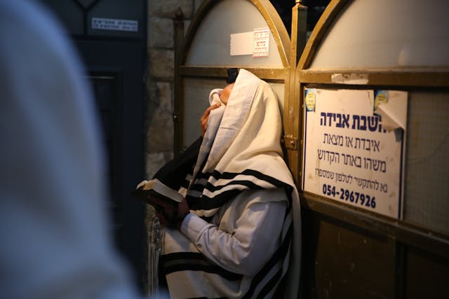 Man Covering Eyes While Praying