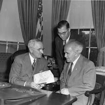 President Harry S. Truman (left) meets with Israeli Prime Minister David Ben-Gurion (right) and Israeli Ambassador Abba Eban (standing) in a gift ceremony in the Oval Office. President Harry S. Truman (left) meets with Israeli Prime Minister David Ben-Gurion (right) and Israeli Ambassador Abba Eban (standing) in a gift ceremony in the Oval Office.