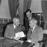 President Harry S. Truman (left) meets with Israeli Prime Minister David Ben-Gurion (right) and Israeli Ambassador Abba Eban (standing) in a gift ceremony in the Oval Office. President Harry S. Truman (left) meets with Israeli Prime Minister David Ben-Gurion (right) and Israeli Ambassador Abba Eban (standing) in a gift ceremony in the Oval Office.