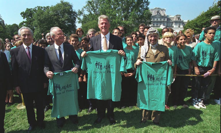 Clinton, Rabin, Arafat holding up T-shirts celebrating peace deal (White House Photograph Office via Wikimedia) Clinton, Rabin, Arafat holding up T-shirts celebrating peace deal (White House Photograph Office via Wikimedia)
