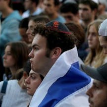 Man wearing kippah and Israeli flag Man wearing kippah and Israeli flag
