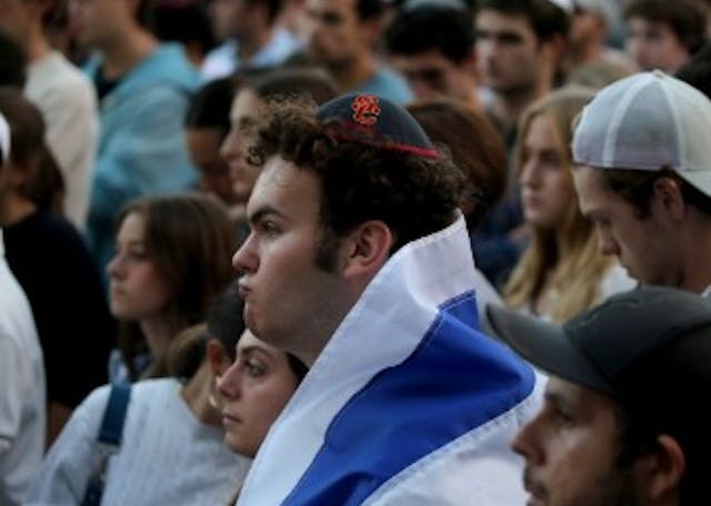 Man wearing kippah and Israeli flag Man wearing kippah and Israeli flag