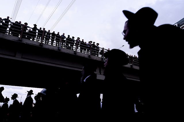Haredi anti-conscription protesters block a road in Bnei Brak