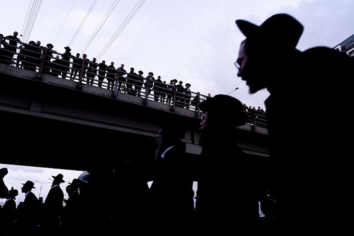 Haredi anti-conscription protesters block a road in Bnei Brak