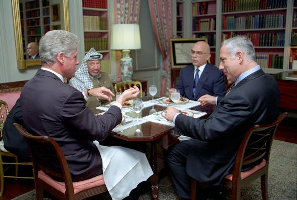 President Bill Clinton has lunch with King Hussein of Jordan, Prime Minister Benjamin Netanyahu of Israel, and Chairman Yasser Arafat of the Palestinian Authority (Wikimedia Commons)