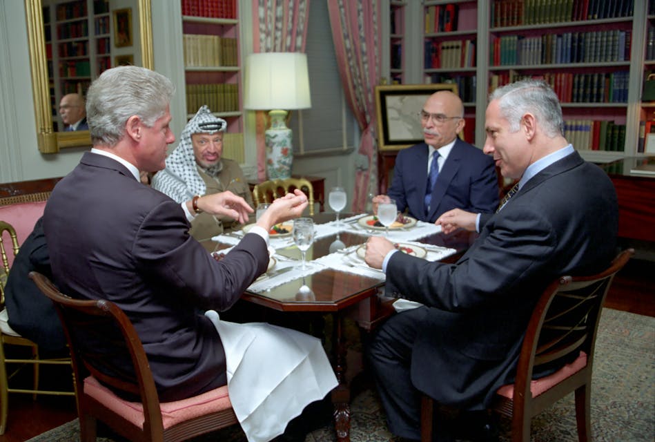 President Bill Clinton has lunch with King Hussein of Jordan, Prime Minister Benjamin Netanyahu of Israel, and Chairman Yasser Arafat of the Palestinian Authority (Wikimedia Commons)