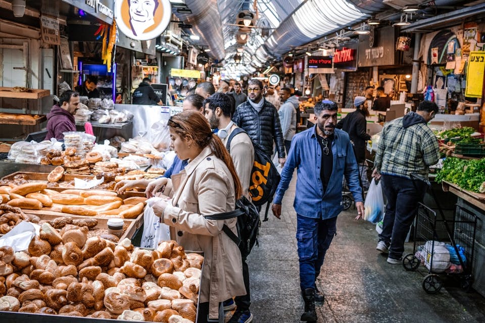 People shopping at Mahane Yehuda in Jerusalem, December 22, 2023 (Shutterstock)