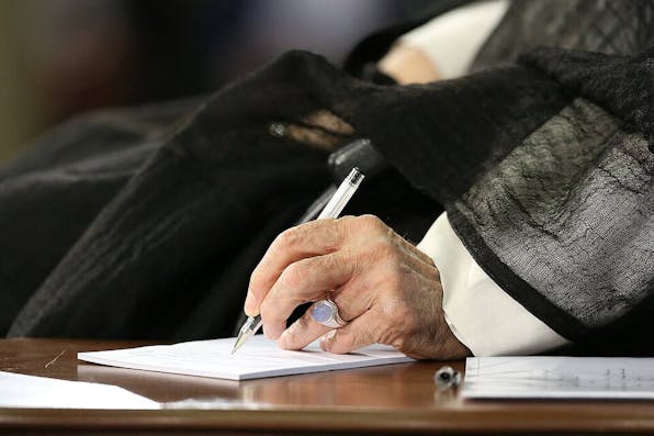 Ali Khamenei signing a document. Wikimedia Commons. Ali Khamenei signing a document. Wikimedia Commons.