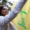 Woman with Hizballah flag at pro-Assad protest in Paris, 2013. (Kenzo Tribouillard/AFP via Getty Images) Woman with Hizballah flag at pro-Assad protest in Paris, 2013. (Kenzo Tribouillard/AFP via Getty Images)