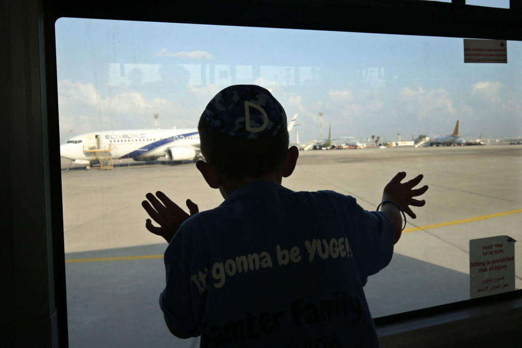 Watching Jewish immigrants arrive at Ben-Gurion Airport, August 17, 2016. (Gali Tibbon/AFP via Getty Images)