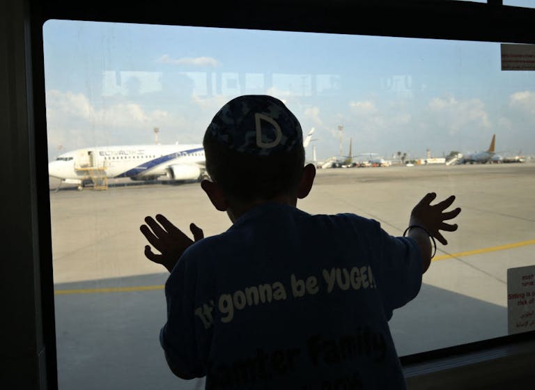 Watching Jewish immigrants arrive at Ben-Gurion Airport, August 17, 2016. (Gali Tibbon/AFP via Getty Images) Watching Jewish immigrants arrive at Ben-Gurion Airport, August 17, 2016. (Gali Tibbon/AFP via Getty Images)