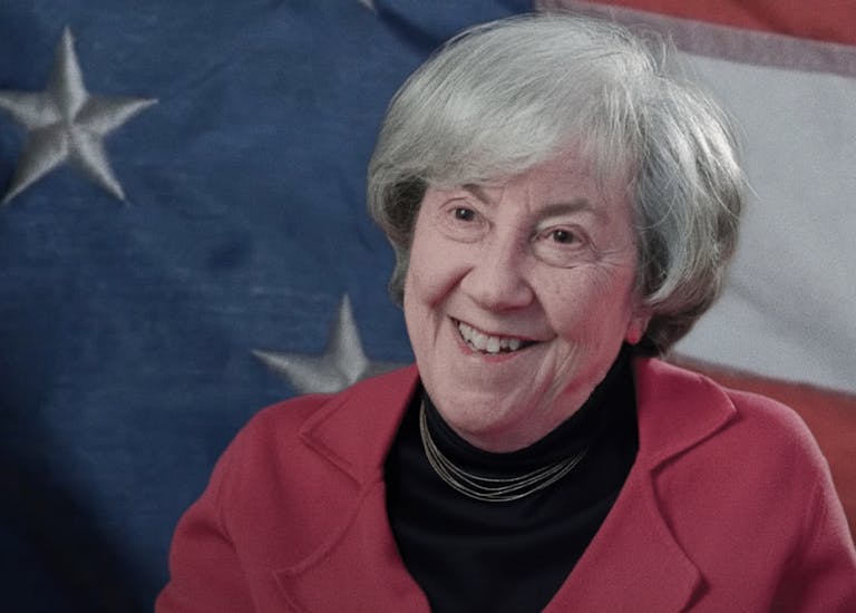 Ruth Wisse in front of an American flag