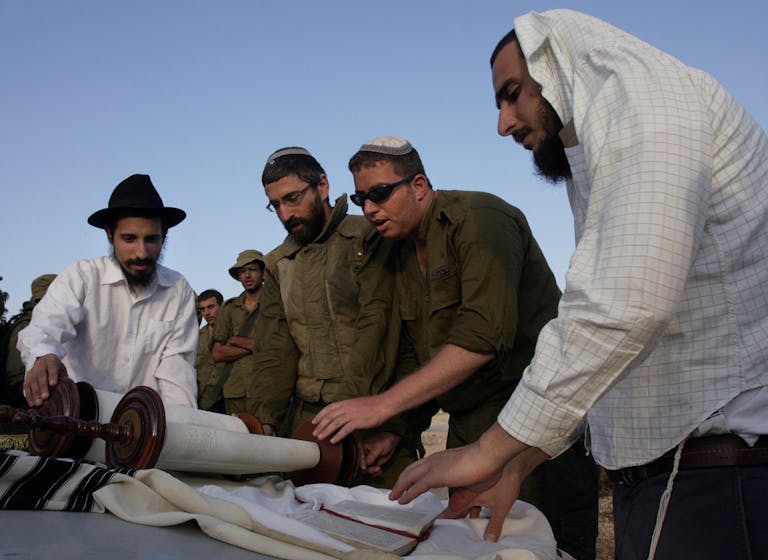 Reading the Torah during the Second Lebanon War. (Denis Sinyakov/AFP via Getty Images) Reading the Torah during the Second Lebanon War. (Denis Sinyakov/AFP via Getty Images)