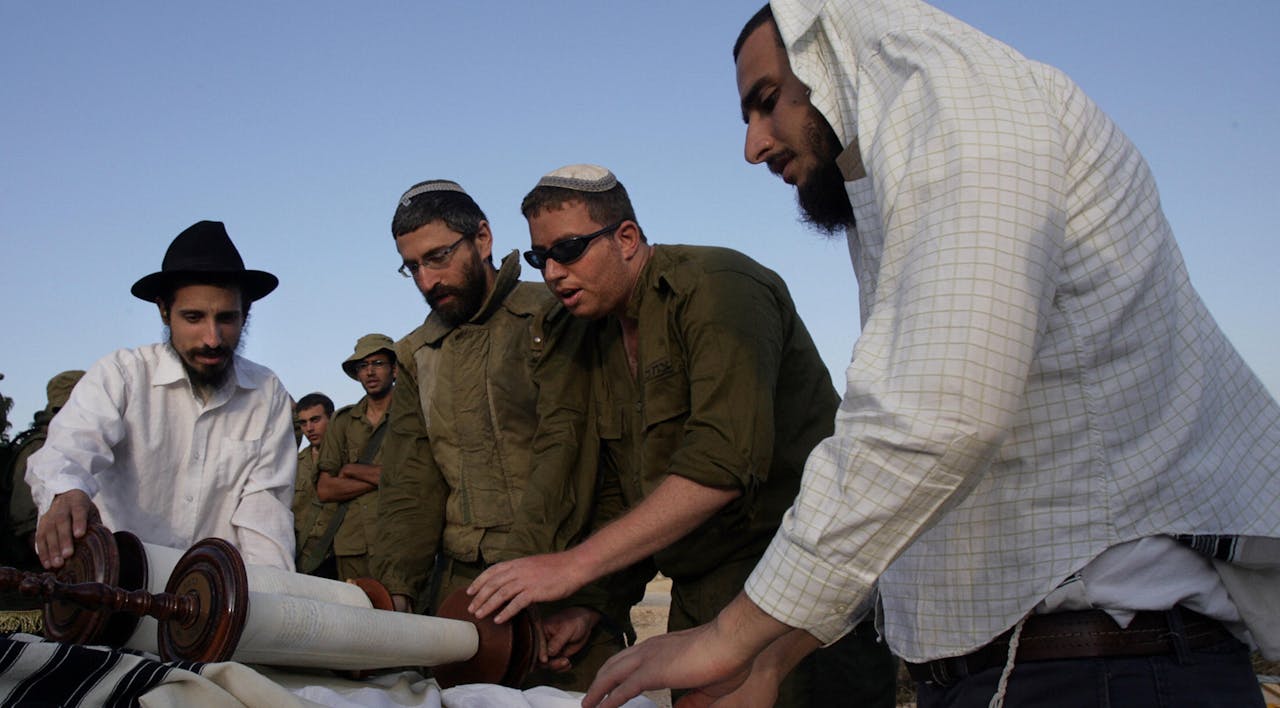 Reading the Torah during the Second Lebanon War. (Denis Sinyakov/AFP via Getty Images) Reading the Torah during the Second Lebanon War. (Denis Sinyakov/AFP via Getty Images)